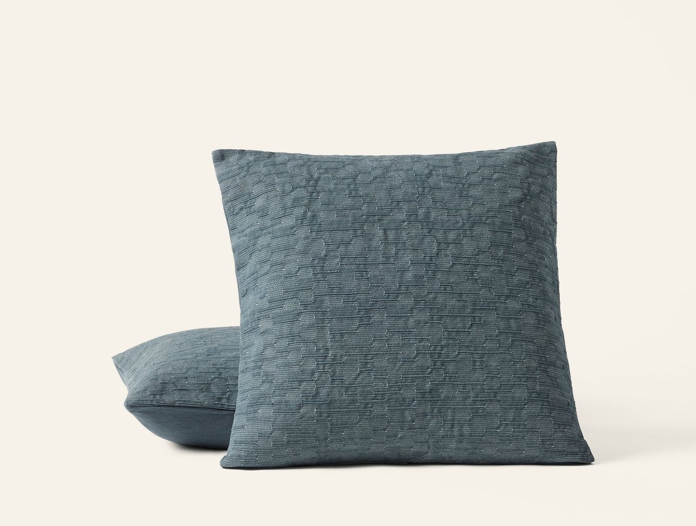 Coyuchi Toro Canyon pillow covers in slate blue with quilted crinkle texture, stacked pair.