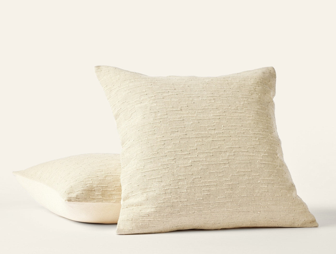 Coyuchi Toro Canyon pillow covers in natural, showing textured woven front and plain back.