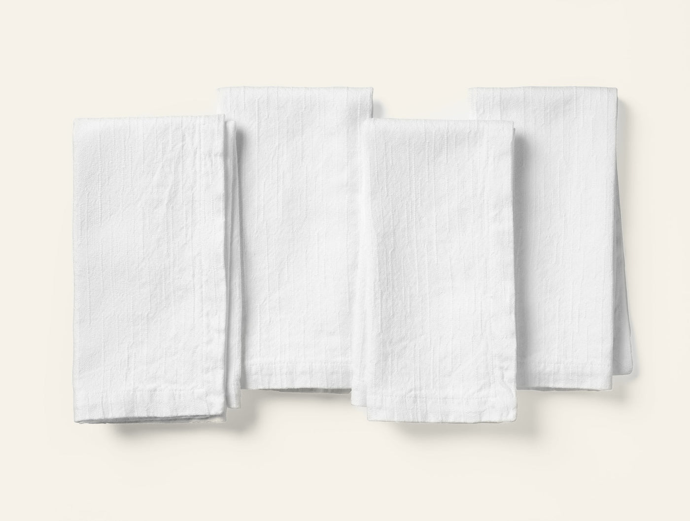 Coyuchi Toro Canyon white textured linen napkin set of four, flat lay view.