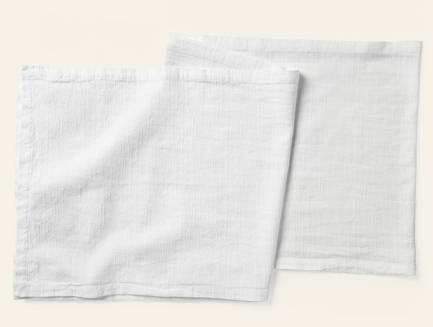 Coyuchi Toro Canyon table runner in white, two napkins shown flat with subtle texture.