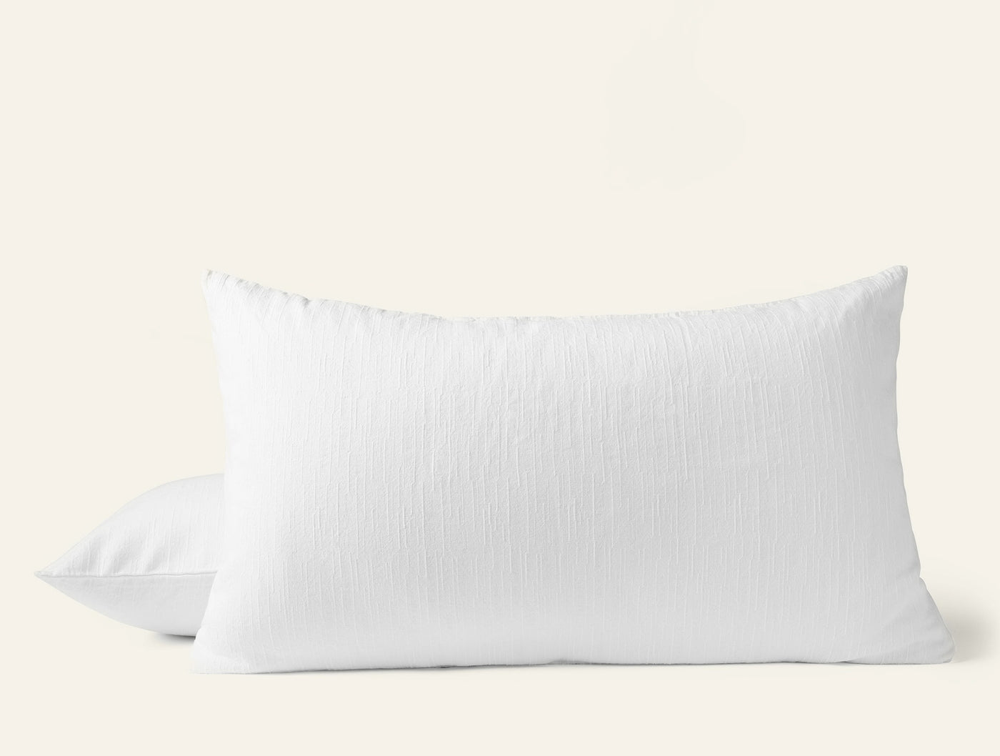 Coyuchi Toro Canyon pillow sham in white with subtle textured stripe weave, two shams stacked.