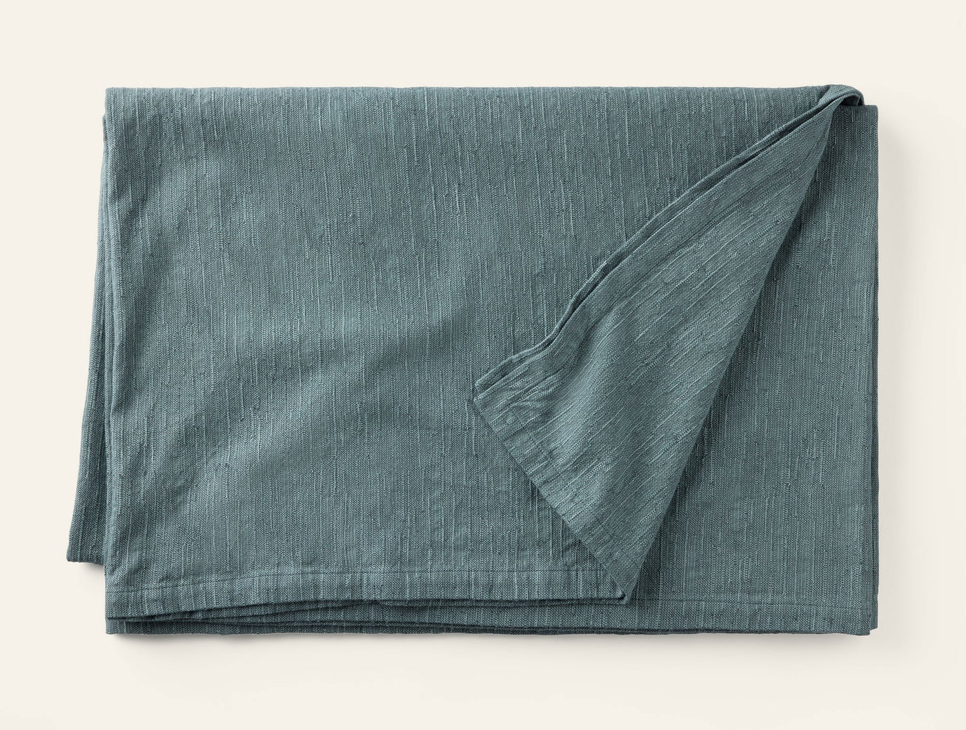 Corner fold detail of Coyuchi Toro Canyon tablecloth in slate blue linen.