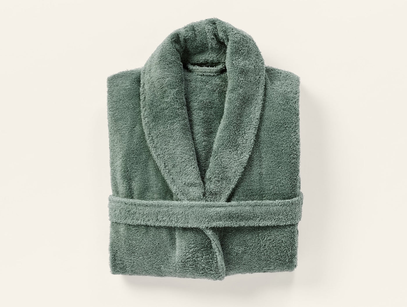 Coyuchi Cloud Loom robe in sage green, folded flat view with shawl collar and belt.