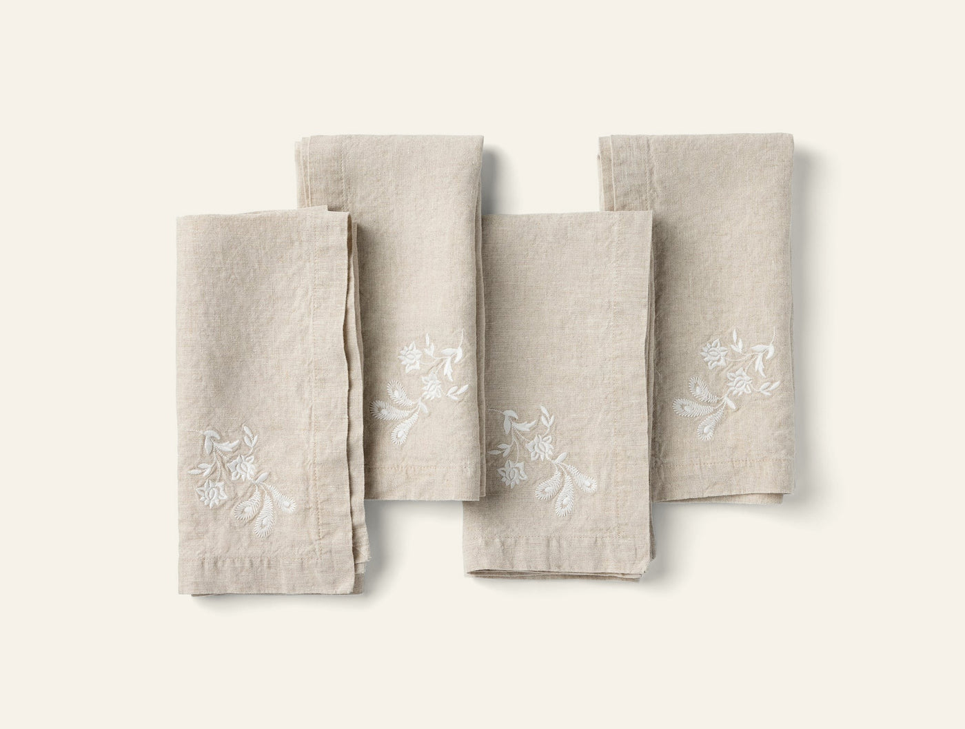 Coyuchi Verbena Embroidered napkin set of four in natural linen with white floral embroidery.