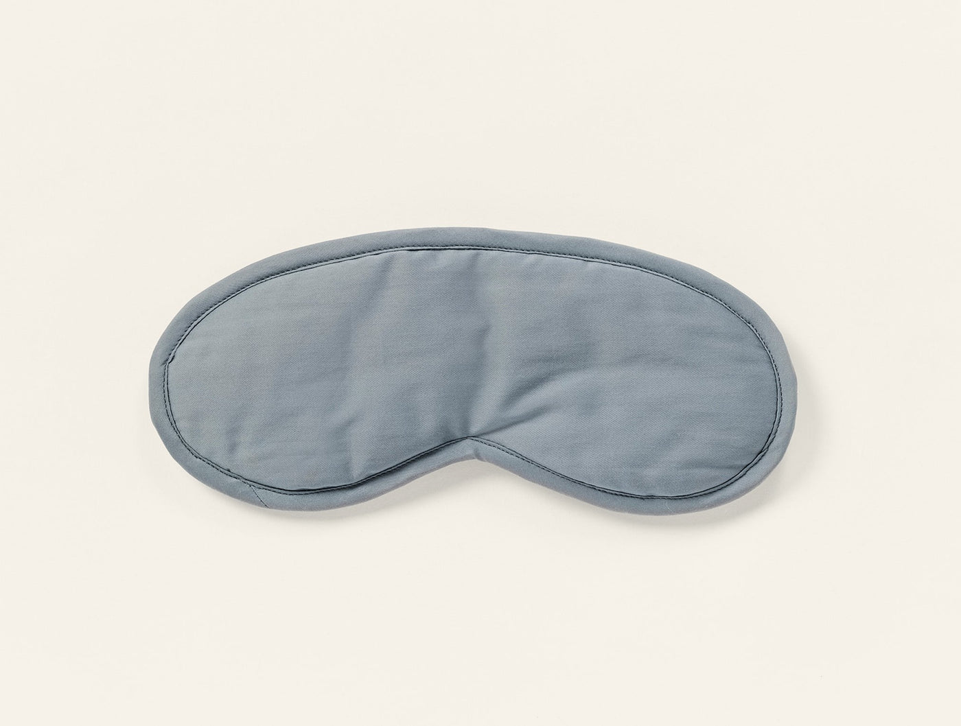 Coyuchi Cloud Soft Sateen eye mask in slate blue, displayed flat on white background.