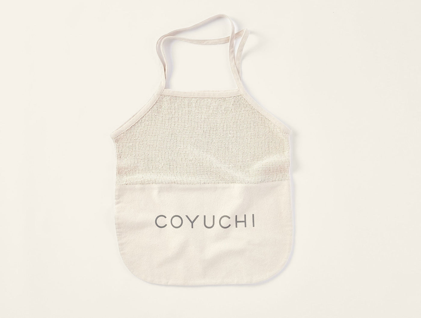 Coyuchi Conserve tote bag in natural, mesh top panel with canvas pocket and logo.