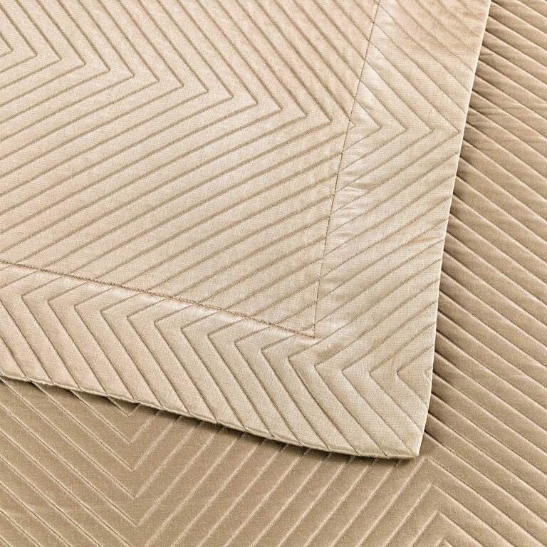 Close-up of Frette's Luxe Herringbone Decorative Sham in beige, highlighting the chevron pattern and the overlapped corner detail.