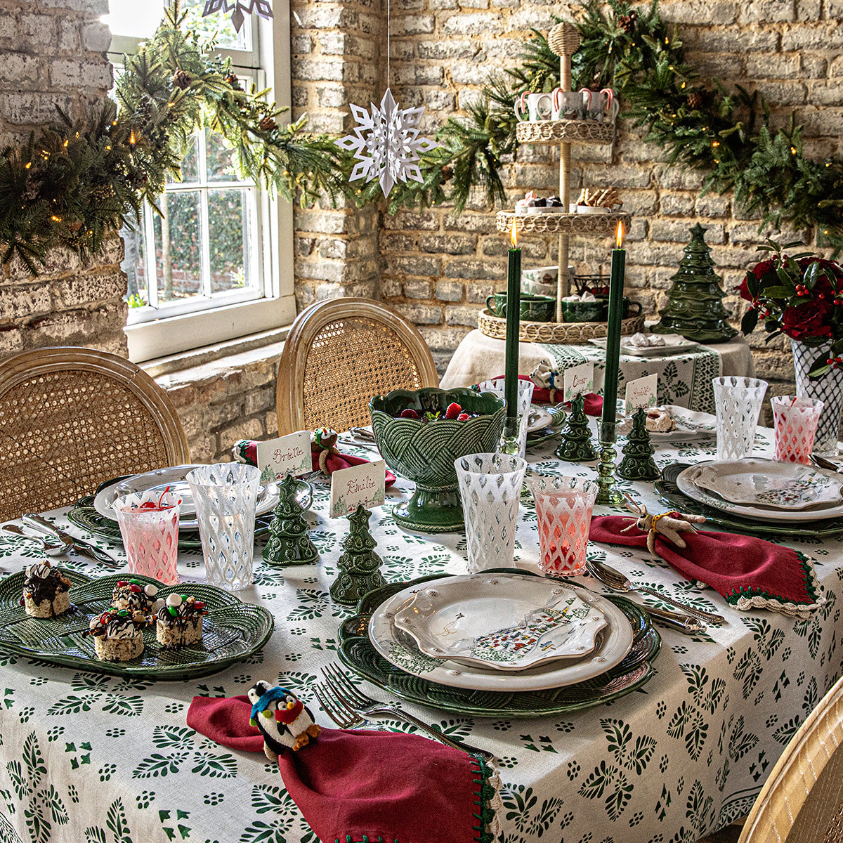 Holiday table in a sunroom set with red napkins in felt animal napkin rings