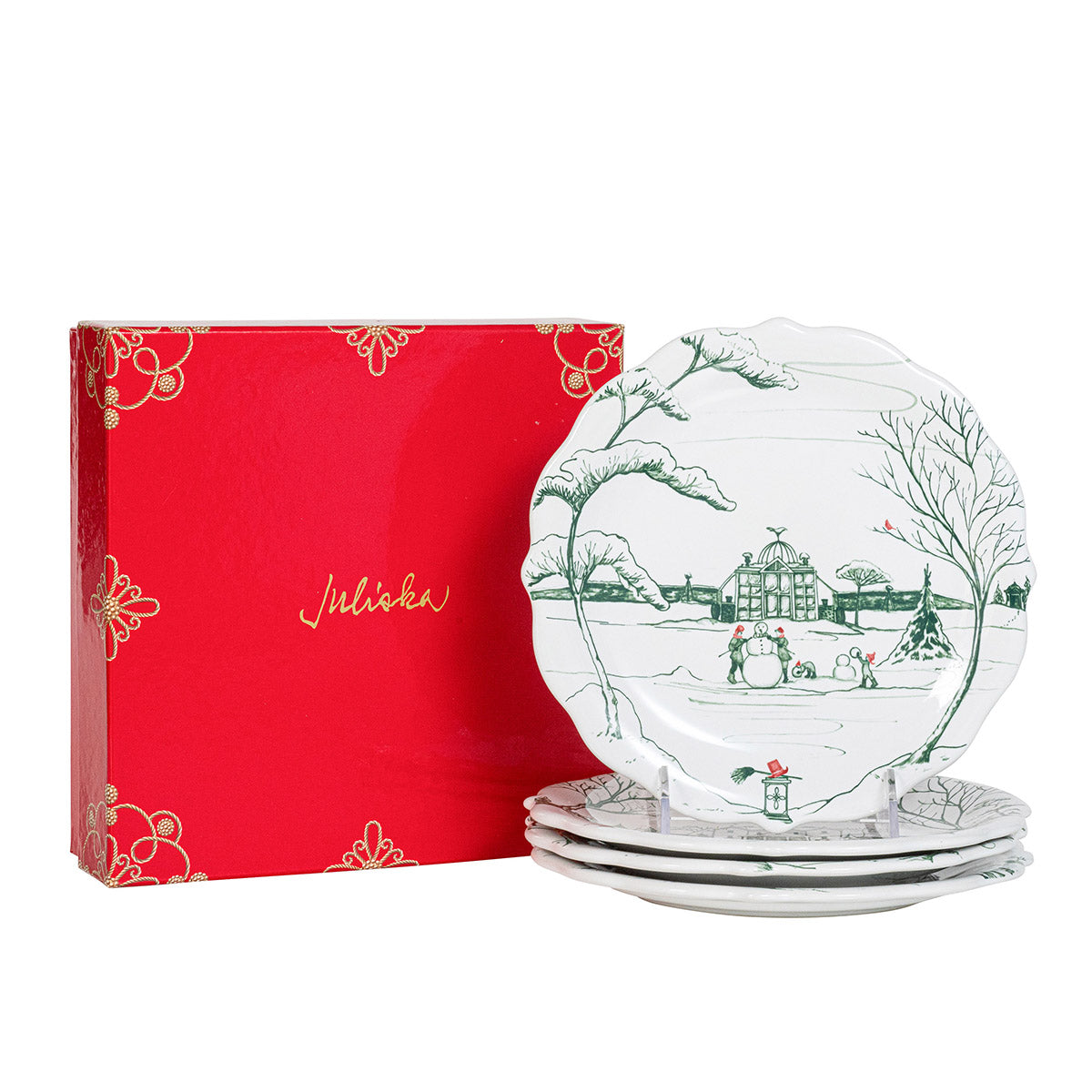 Stack of evergreen Winter Frolic party plates beside a red Juliska gift box