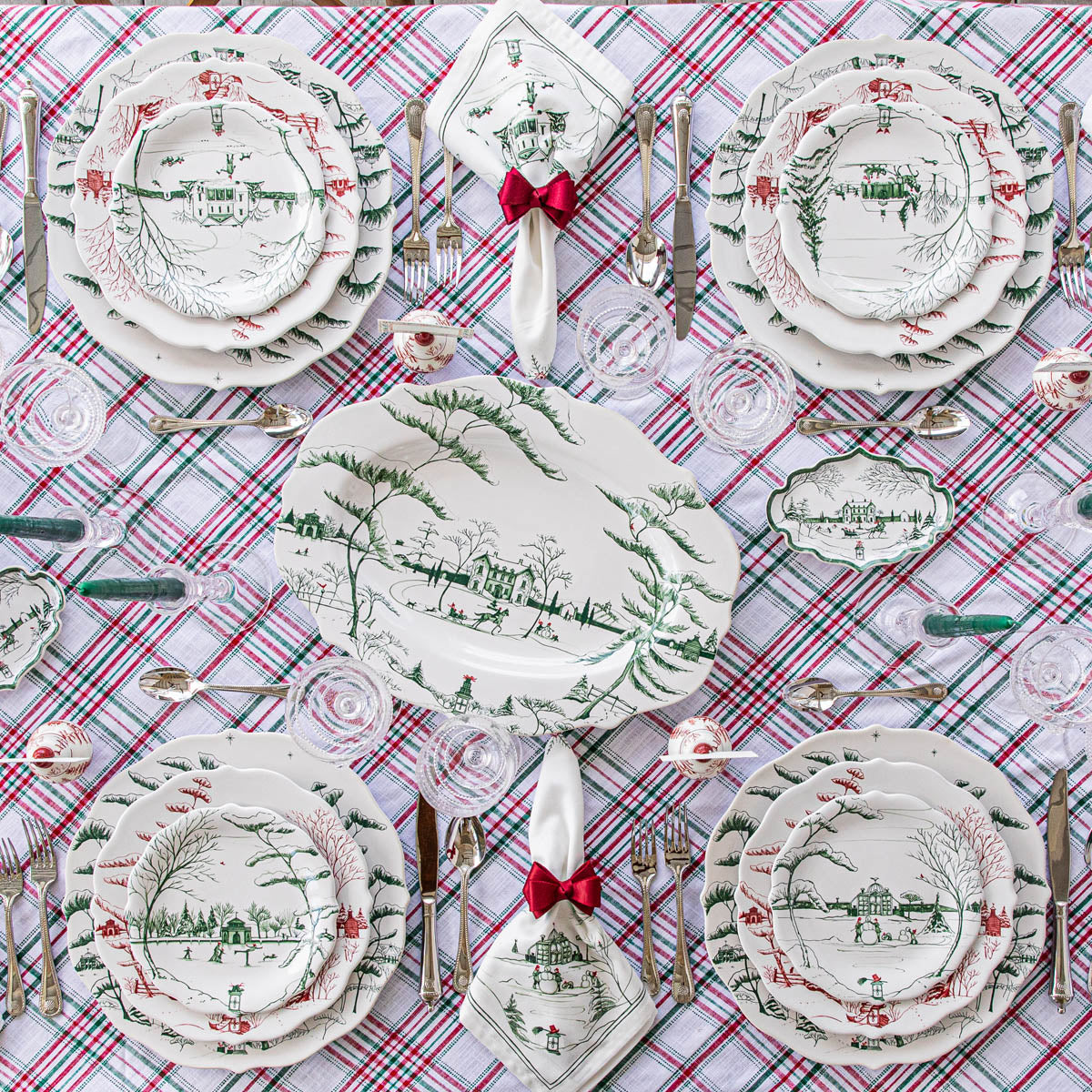 Overhead plaid tablecloth set with an evergreen Winter Frolic platter and place settings