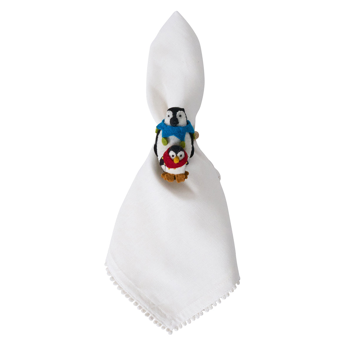 White napkin in a felt penguin napkin ring
