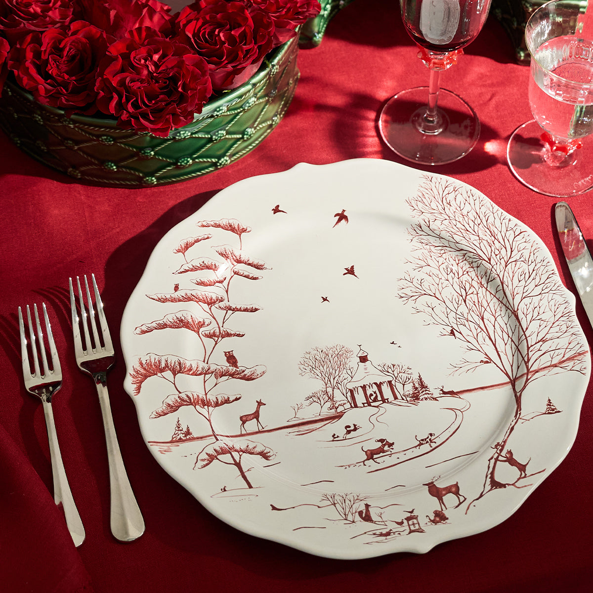 Ruby Winter Frolic charger with a dessert fork on a red tablecloth