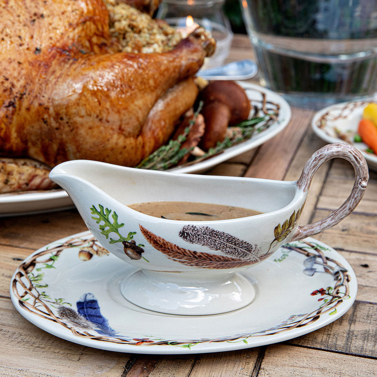 Forest Walk sauce boat with gravy on its stand in front of a roast turkey