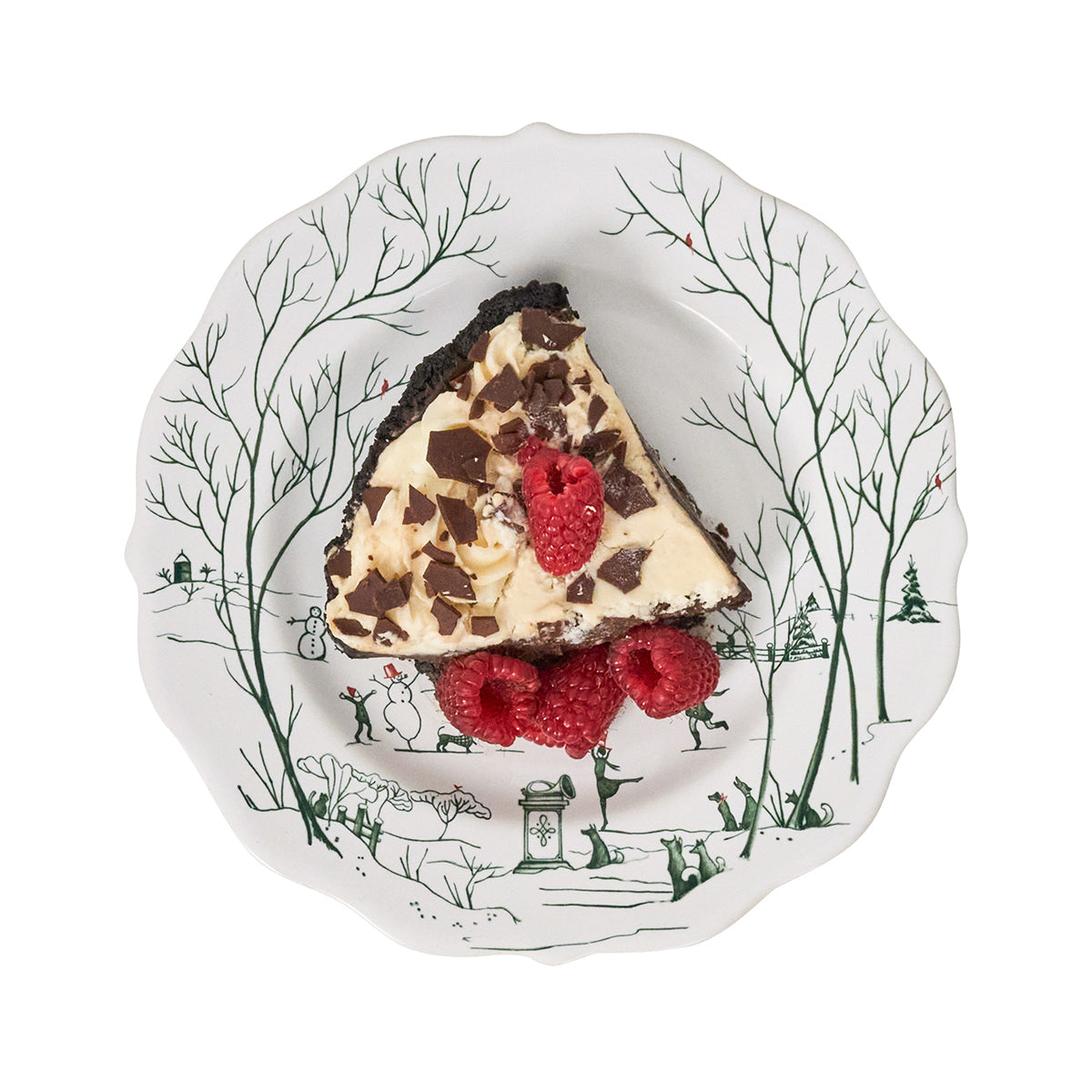 Evergreen Winter Frolic salad plate with a slice of cake and raspberries
