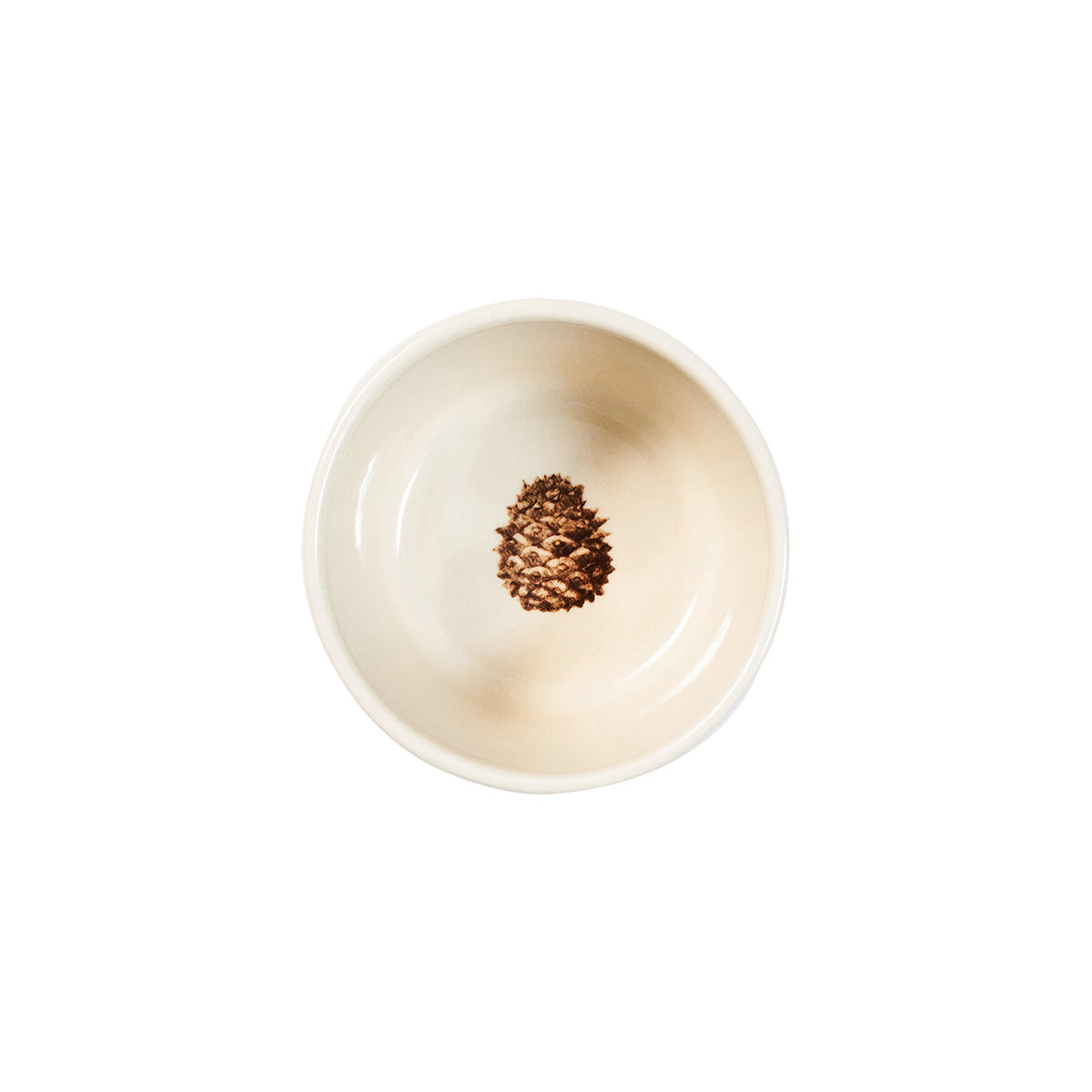 Juliska Forest Walk ramekin viewed from above, showing a single pinecone painted inside
