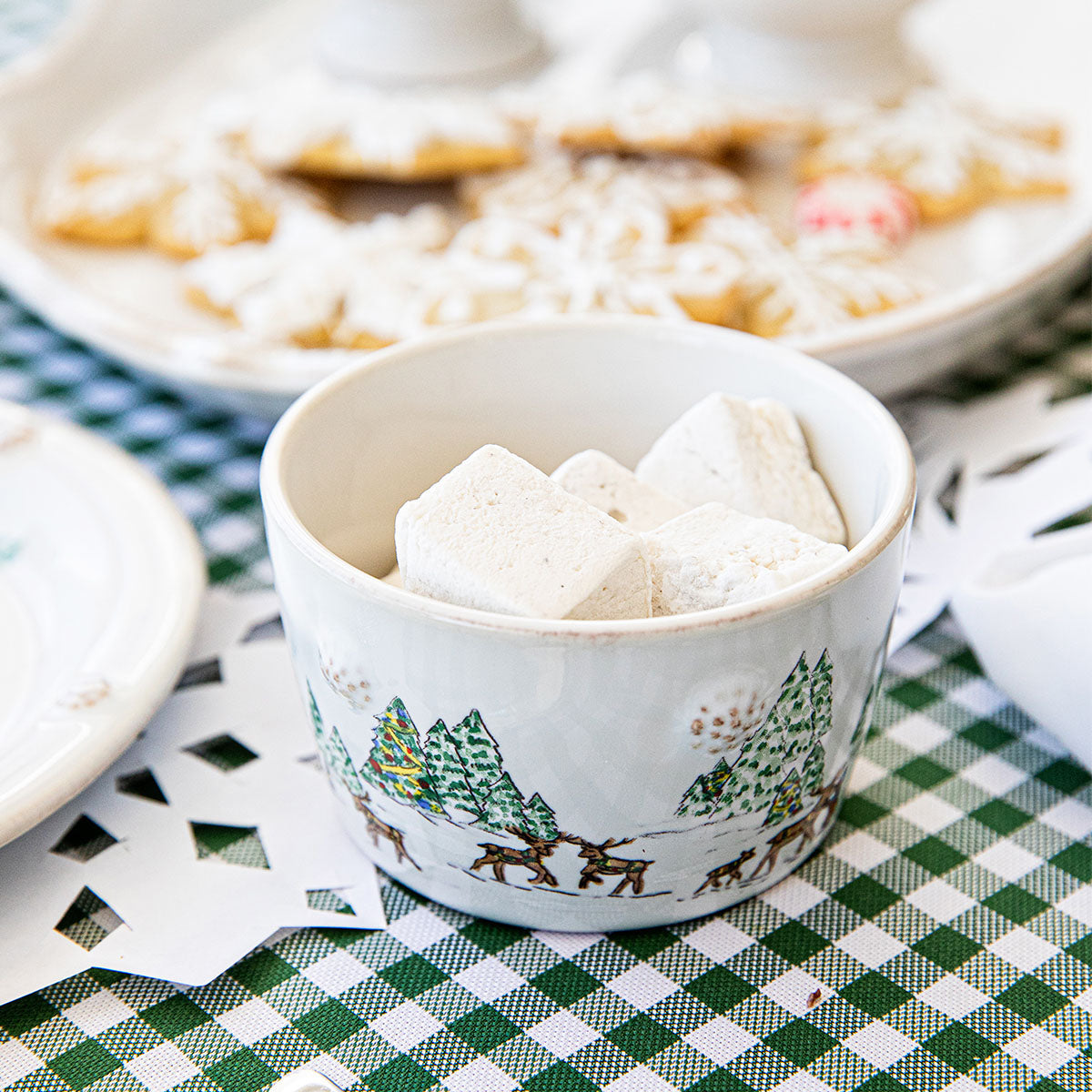North Pole ramekin filled with marshmallows beside a plate of cookies