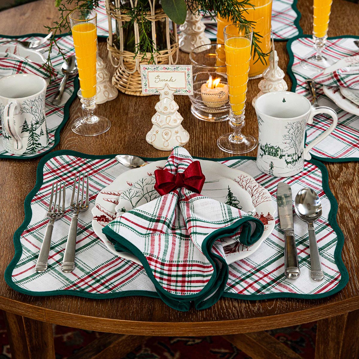 Whitewash tree place card holder at a place setting with a plaid napkin and red bow