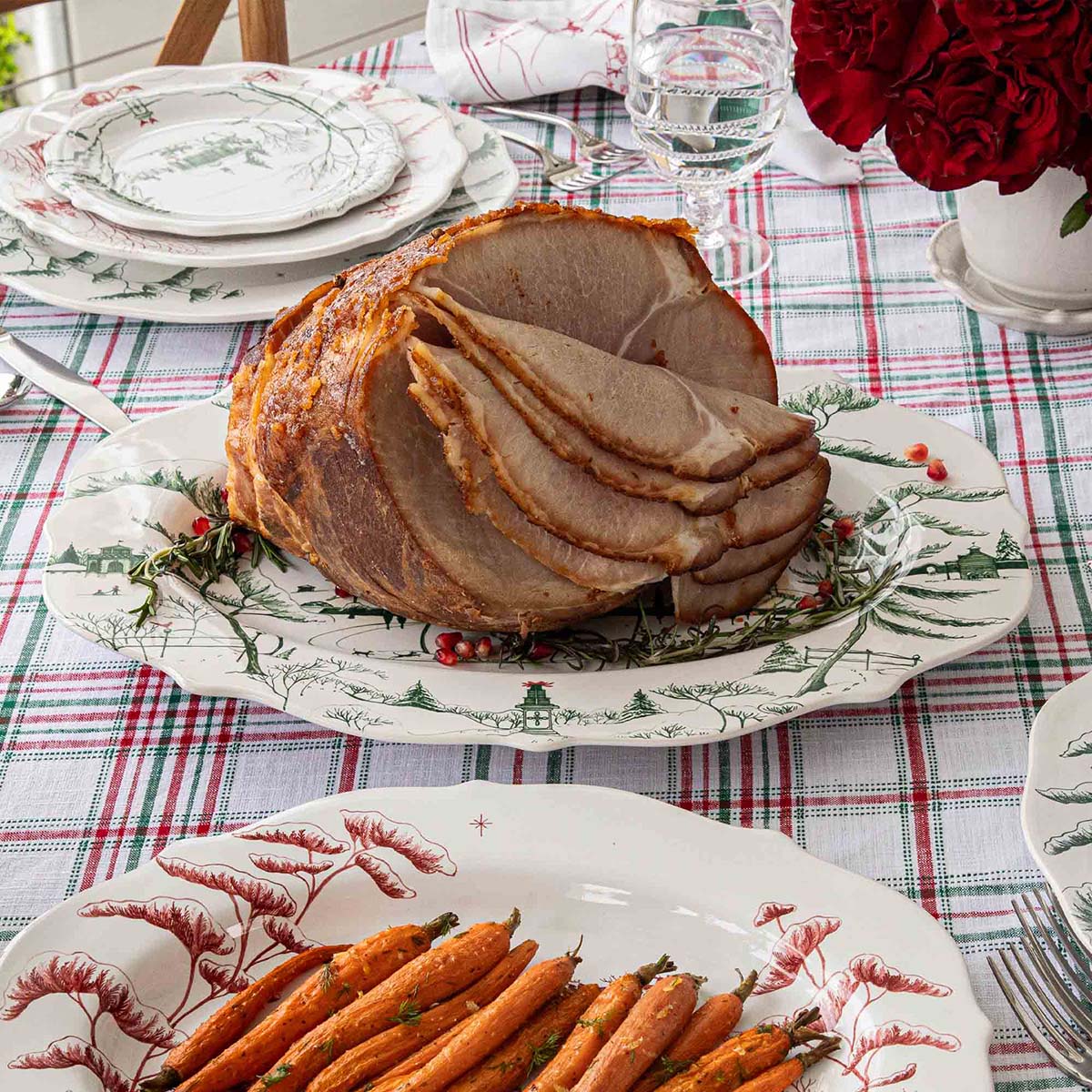 Evergreen Winter Frolic platter holding a glazed ham at a holiday table