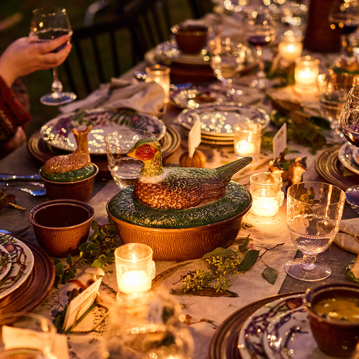 Forest Walk pheasant lidded baker on a candlelit dinner table set with Forest Walk dishes