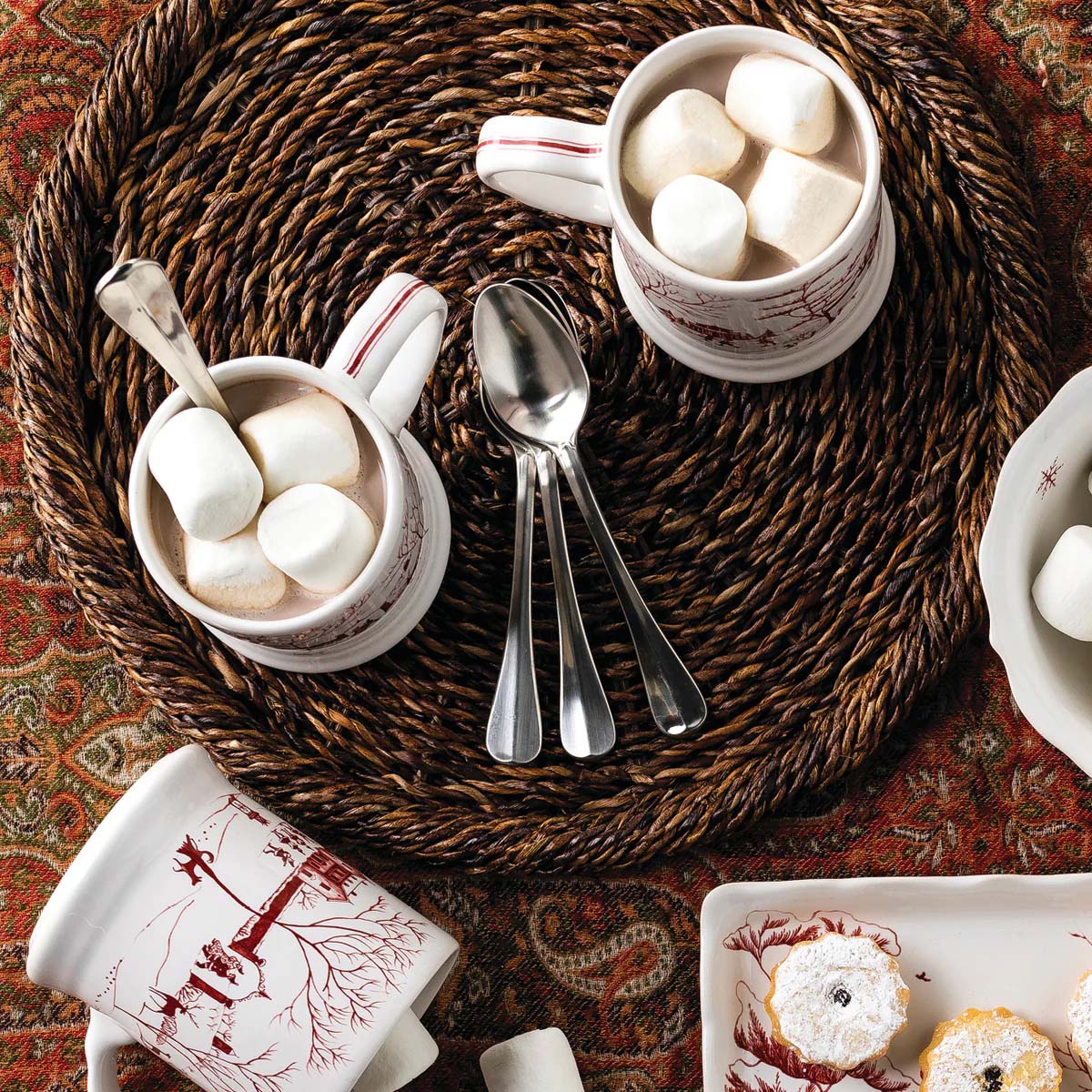 Ruby Santa and Merry mugs with marshmallows on a woven charger