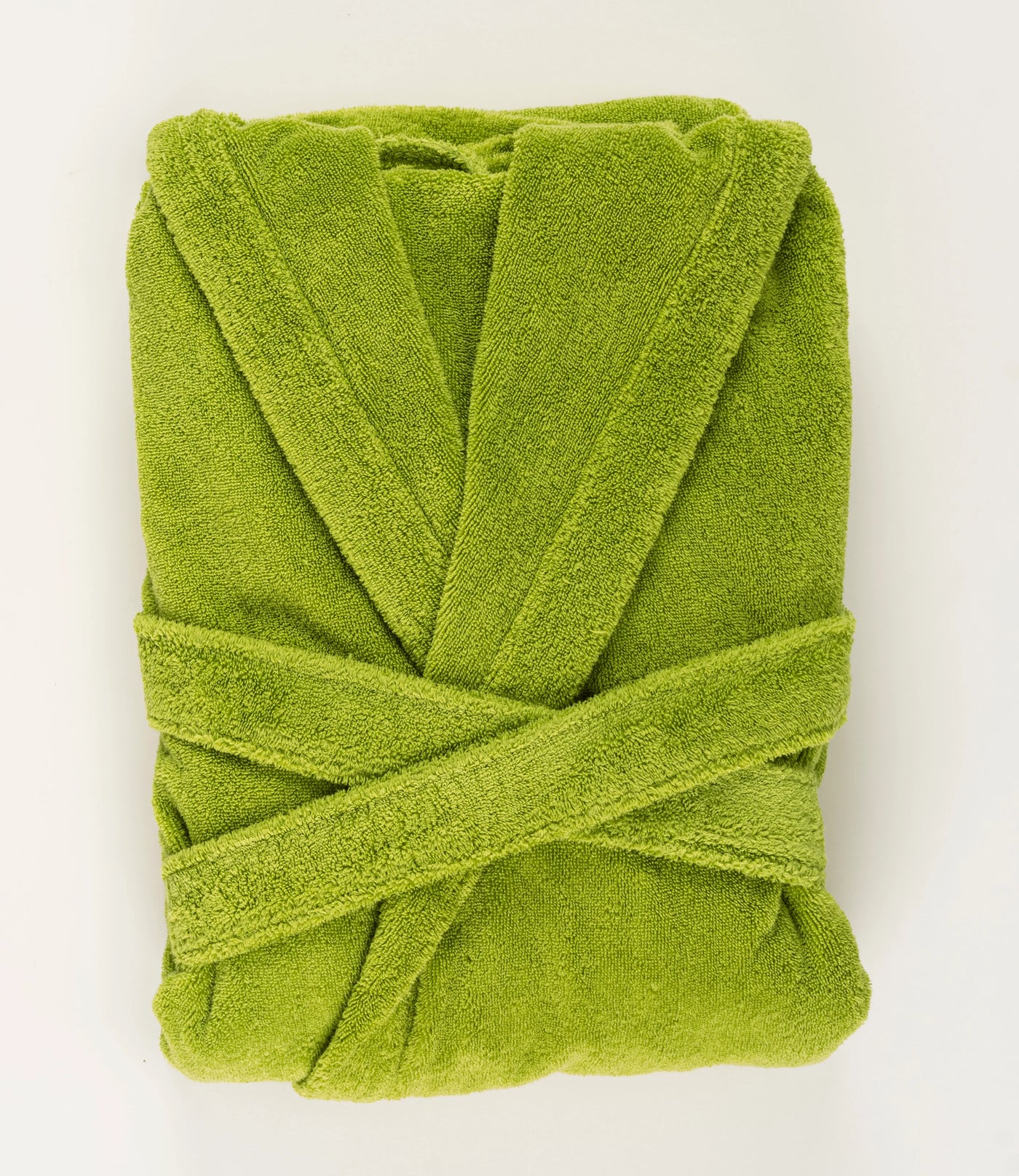 Folded chartreuse terry cotton robe with crossed belt, overhead view.