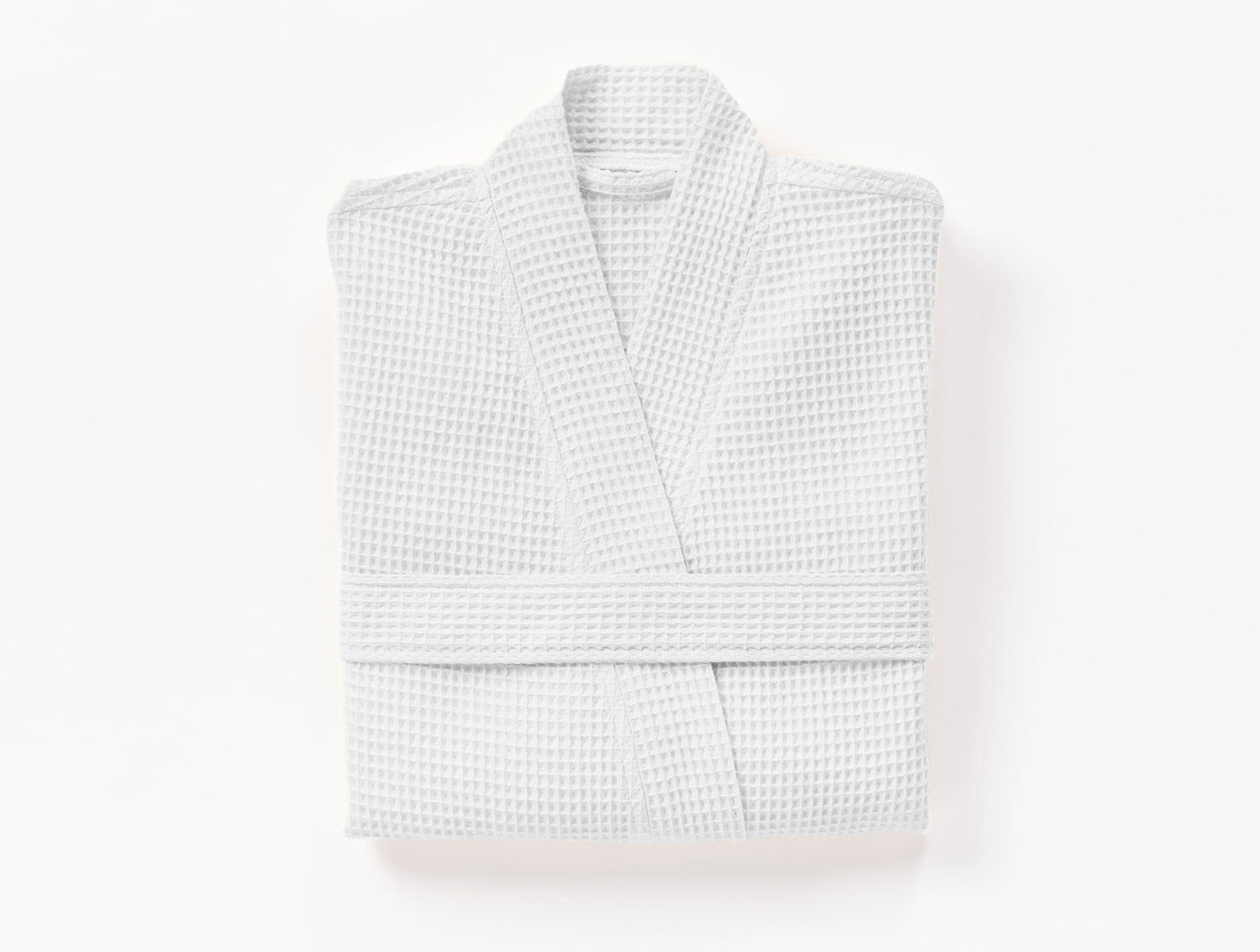 Folded white waffle-knit robe with kimono collar, viewed from above.