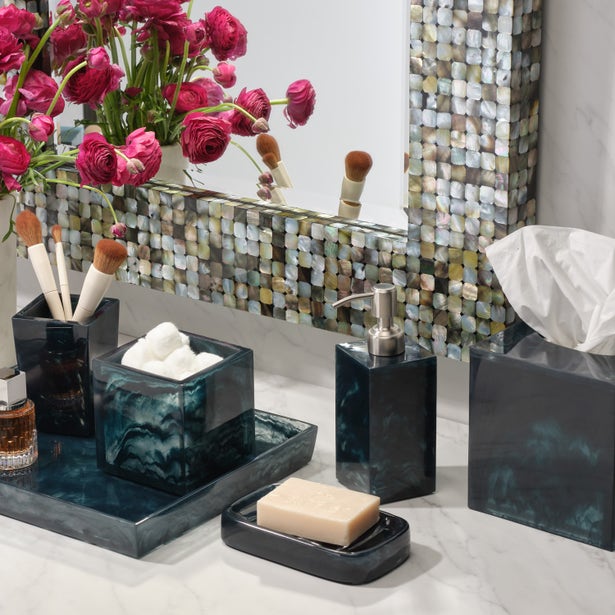 Pigeon & Poodle Abiko bath accessories in teal resin styled on marble vanity with floral arrangement.