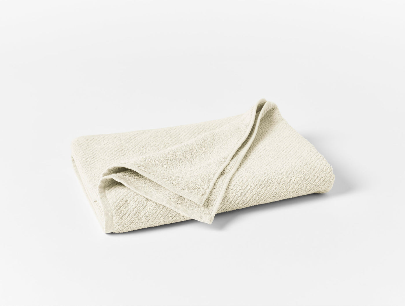 Coyuchi Air Weight oversized hand towel folded, ivory with subtle woven texture.