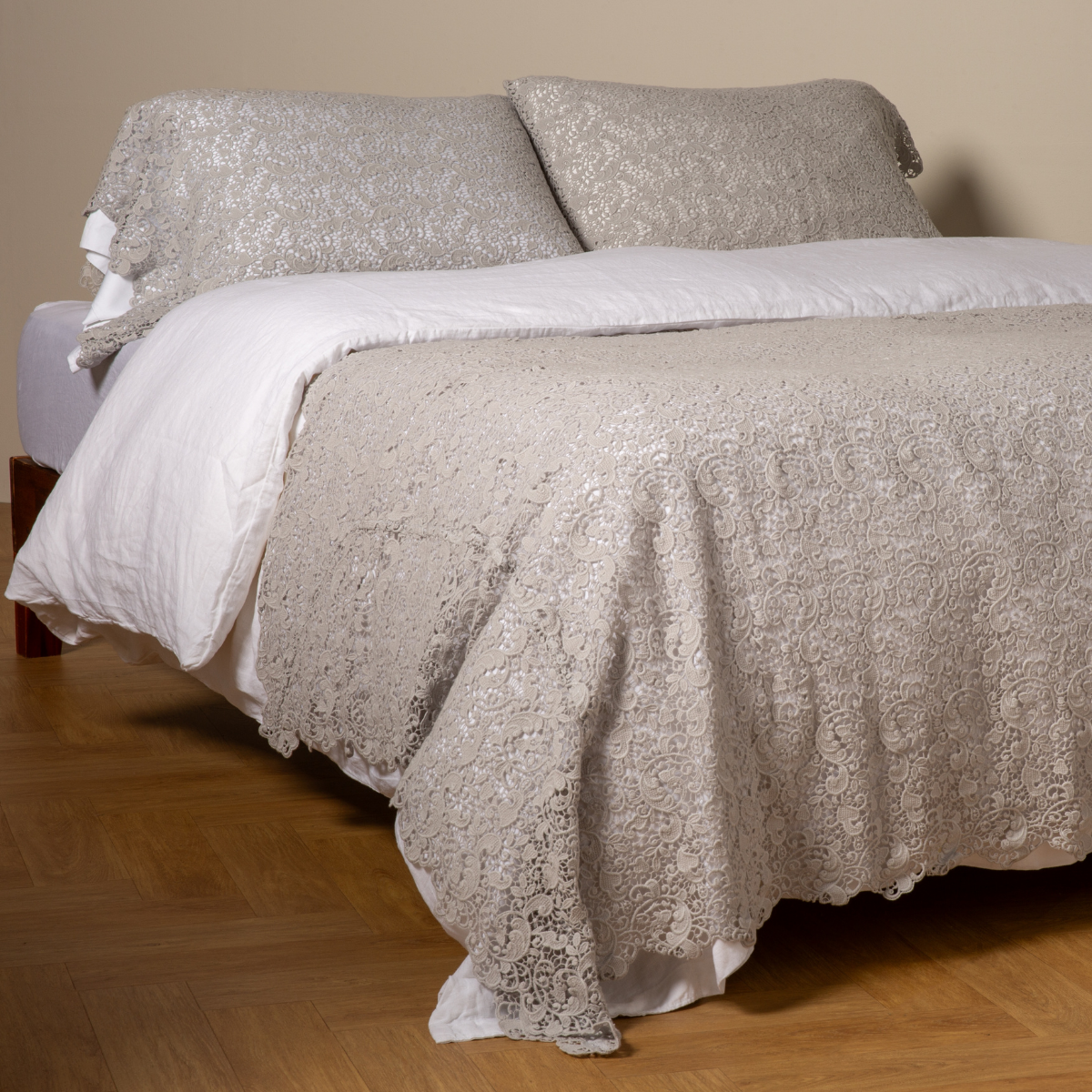 Bella Notte Allora bed scarf in Cloud draped across foot of bed, intricate lace texture.