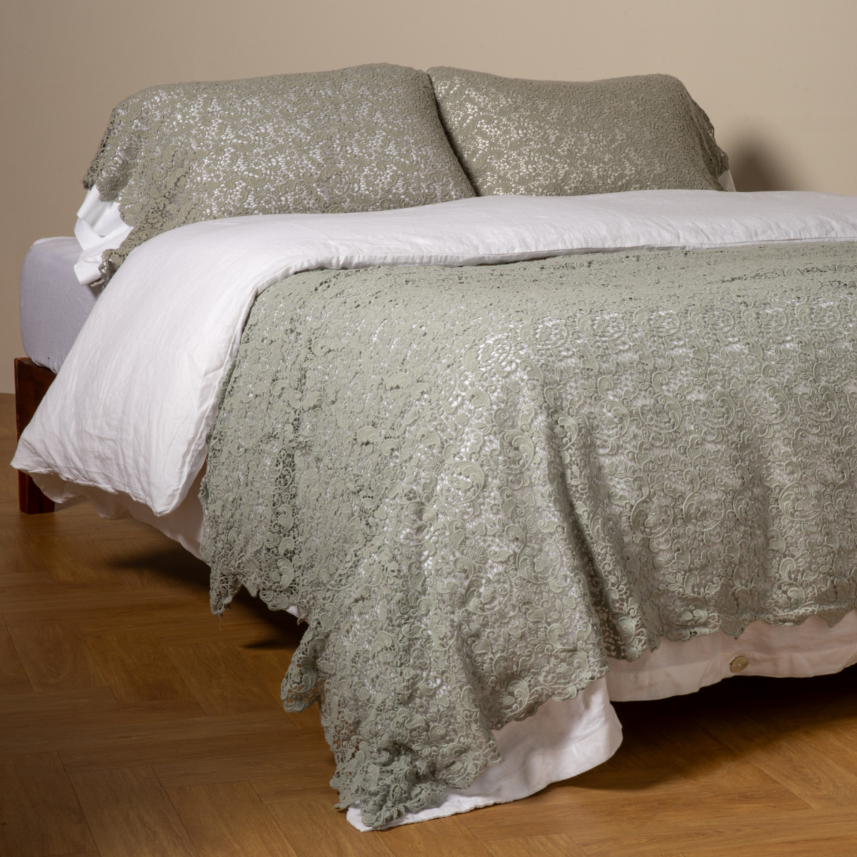 Eucalyptus Allora bed scarf draped over white bedding, showing floral lace texture across full width.