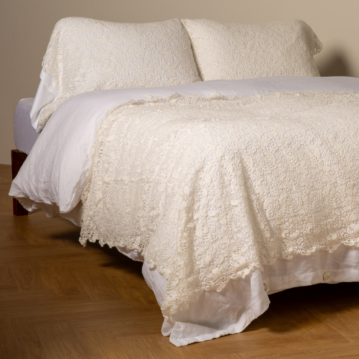 Bella Notte Allora bed scarf in Winter White, draped over bed foot with intricate lace detailing.