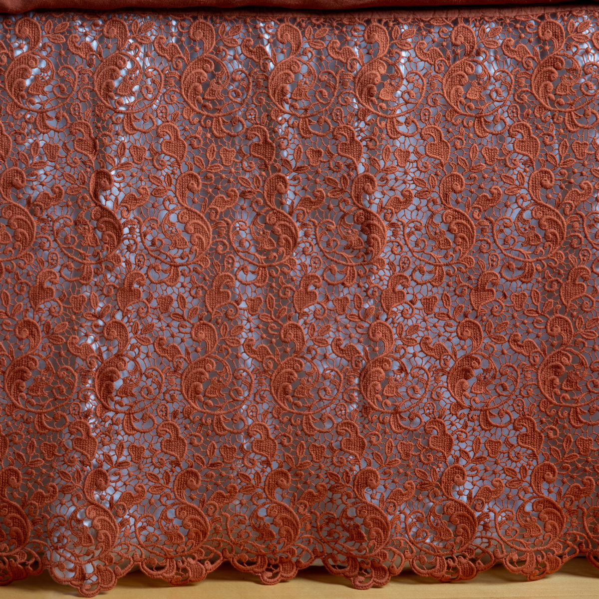 Close-up of Bella Notte Allora bed skirt in Autumn, showing intricate lace scrollwork detail.