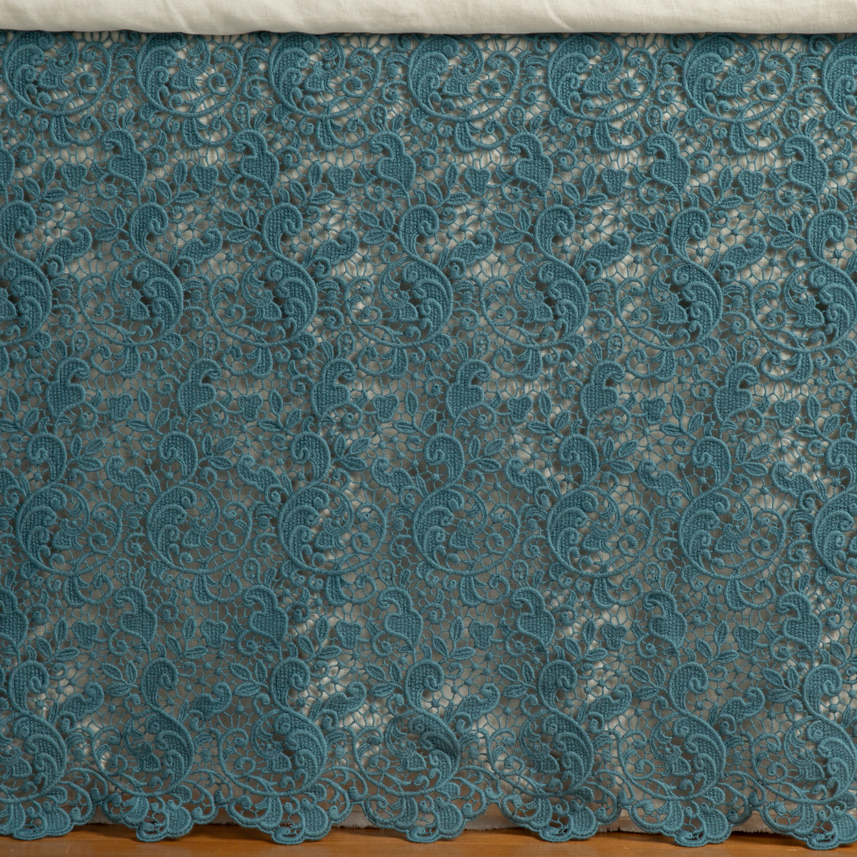 Close-up of Bella Notte Allora bed skirt in Cenote, featuring intricate floral lace overlay with scalloped hem.