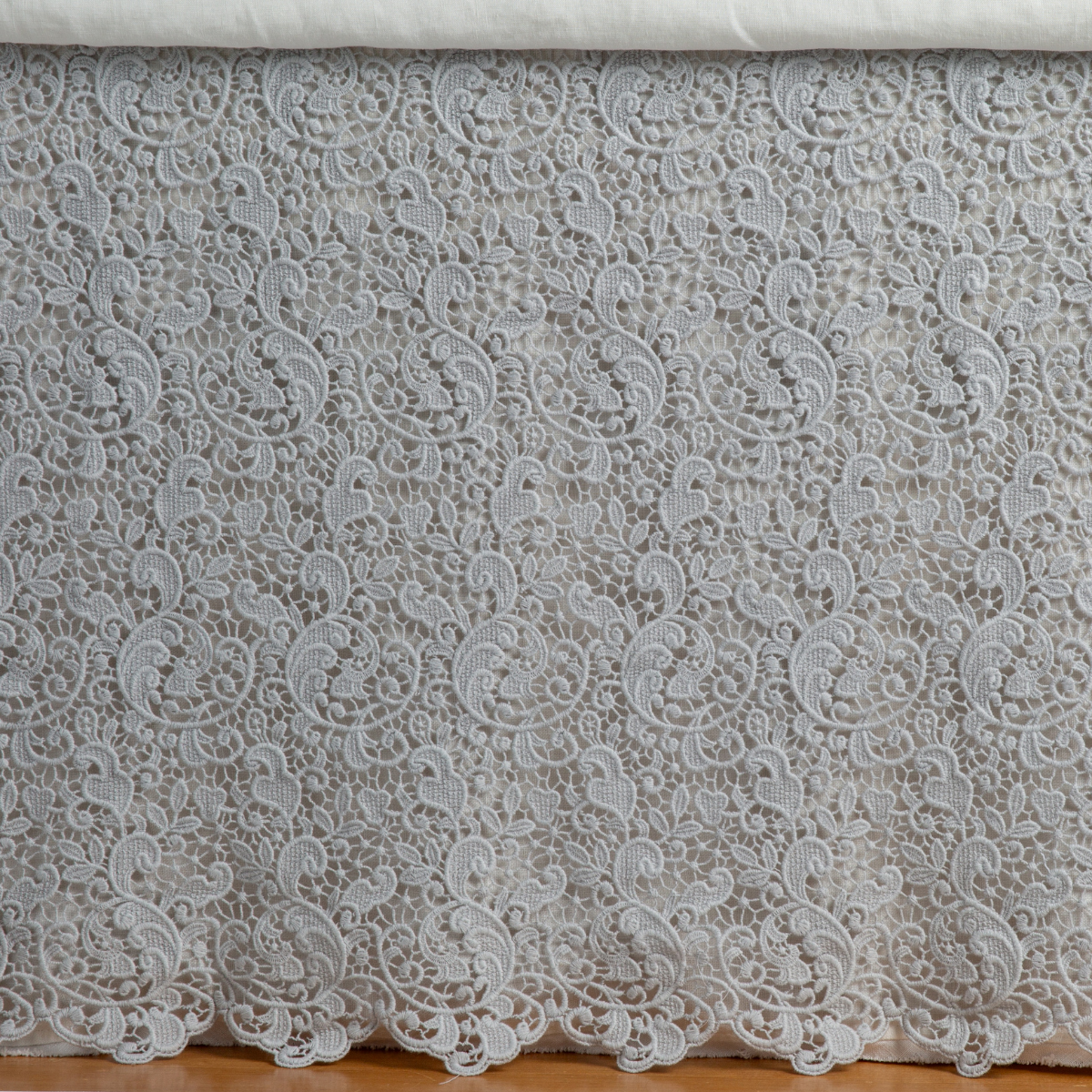 Close-up of Bella Notte Allora bed skirt in Cloud, showing intricate floral lace overlay detail.