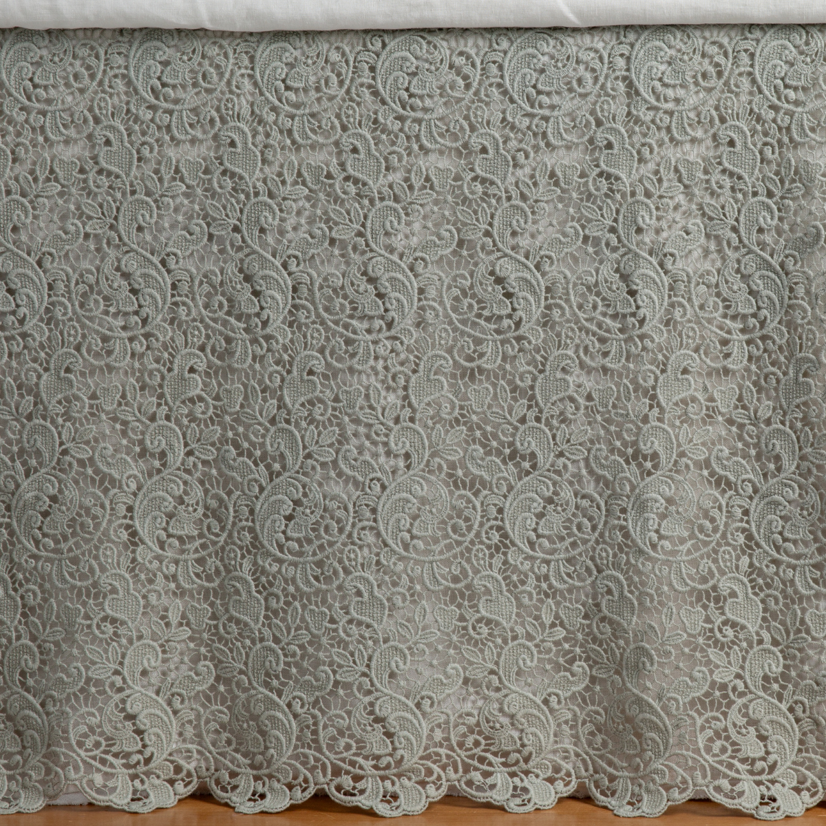 Allora bed skirt in Eucalyptus, close-up of floral lace pattern with scalloped hem.