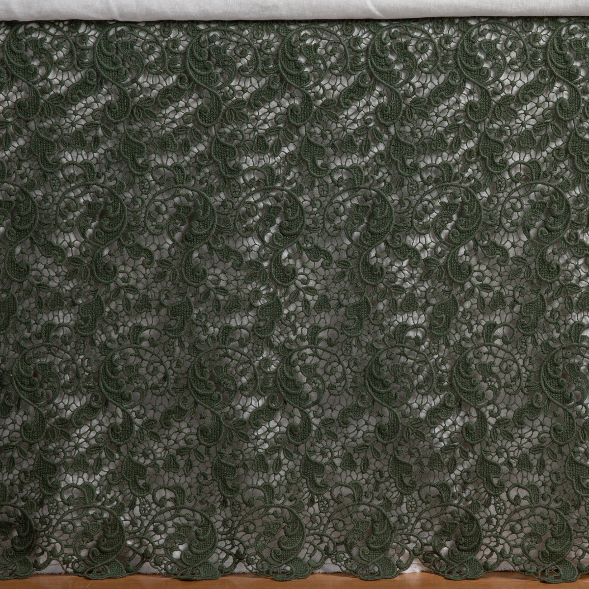 Close-up of Bella Notte Allora bed skirt in Juniper, intricate floral lace detailing.