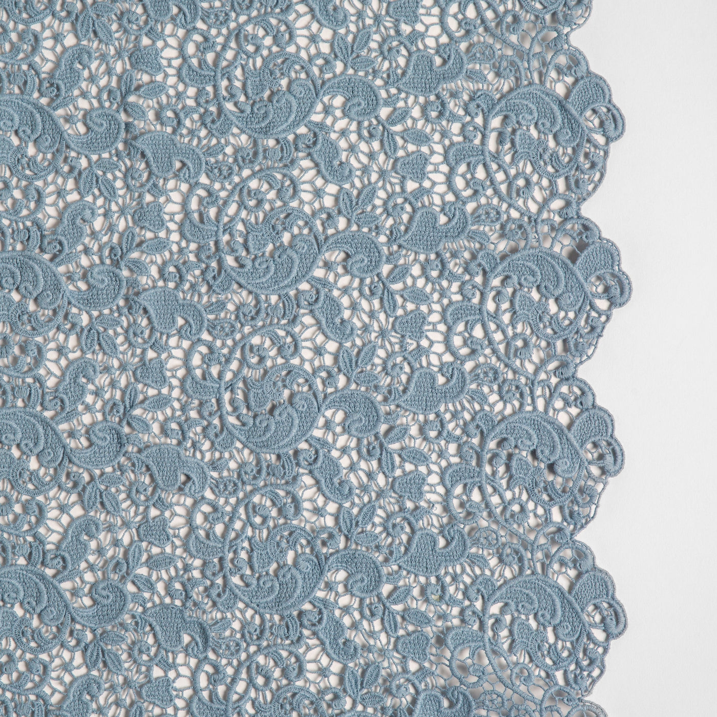 Close-up of Tahoe Blue floral lace pattern with scalloped edge on Bella Notte Allora throw pillow.