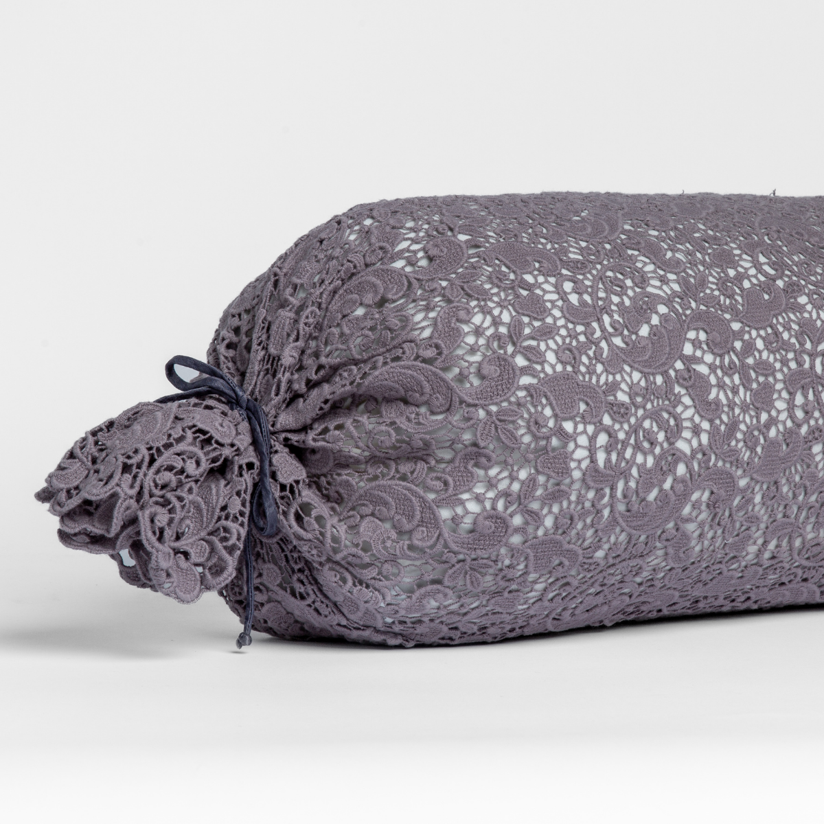 Close-up of Bella Notte Allora Lace throw pillow end, French Lavender lace with tied bow detail.