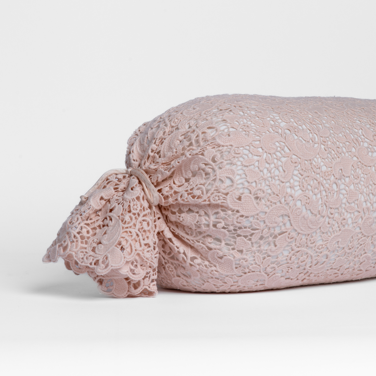 Close-up of Pearl Allora Lace throw pillow showing intricate lace overlay and gathered tie end.