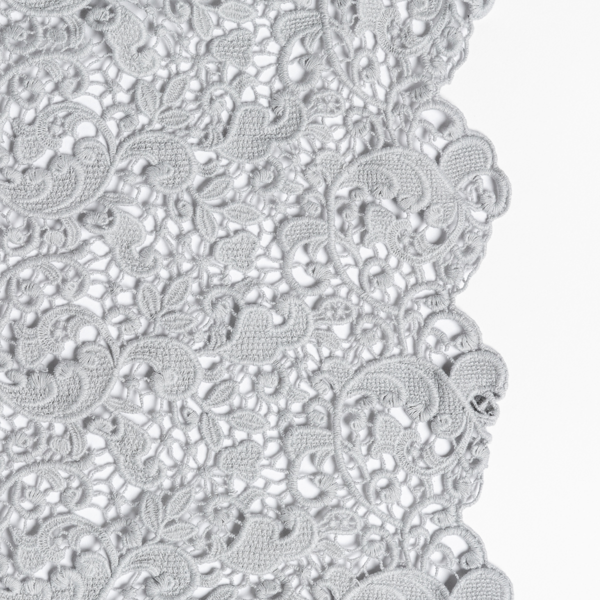 Close-up of Bella Notte Allora Cloud lace edge detail with floral guipure pattern.