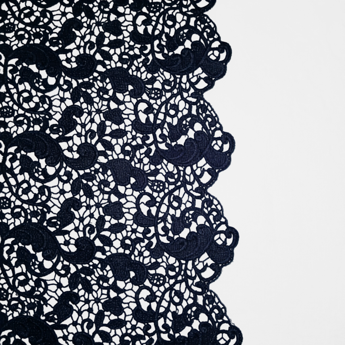 Close-up of Slate Bella Notte Allora bed skirt showing intricate floral lace trim edge.