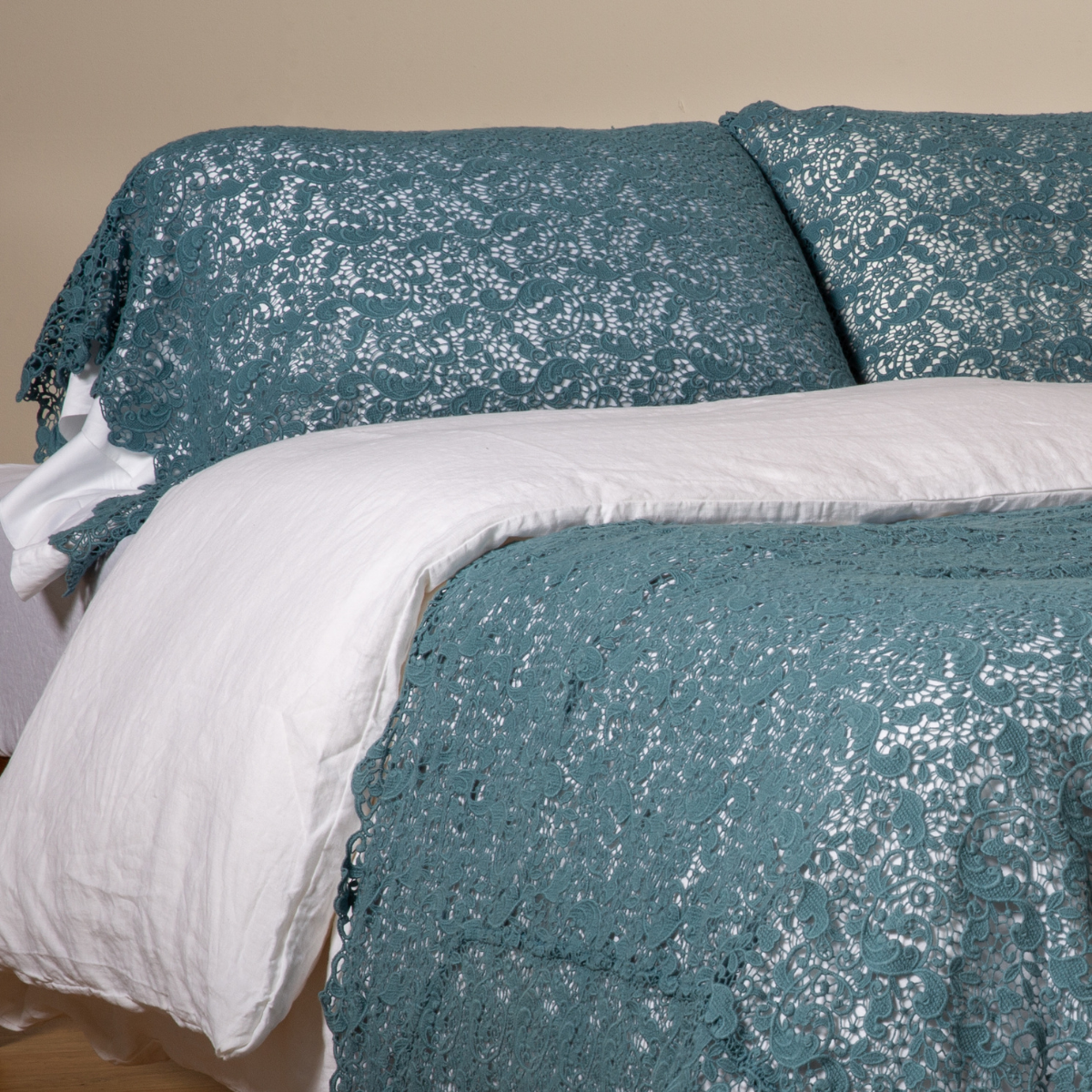 Cenote lace pillowcase on styled bed with matching duvet and white underlinen.