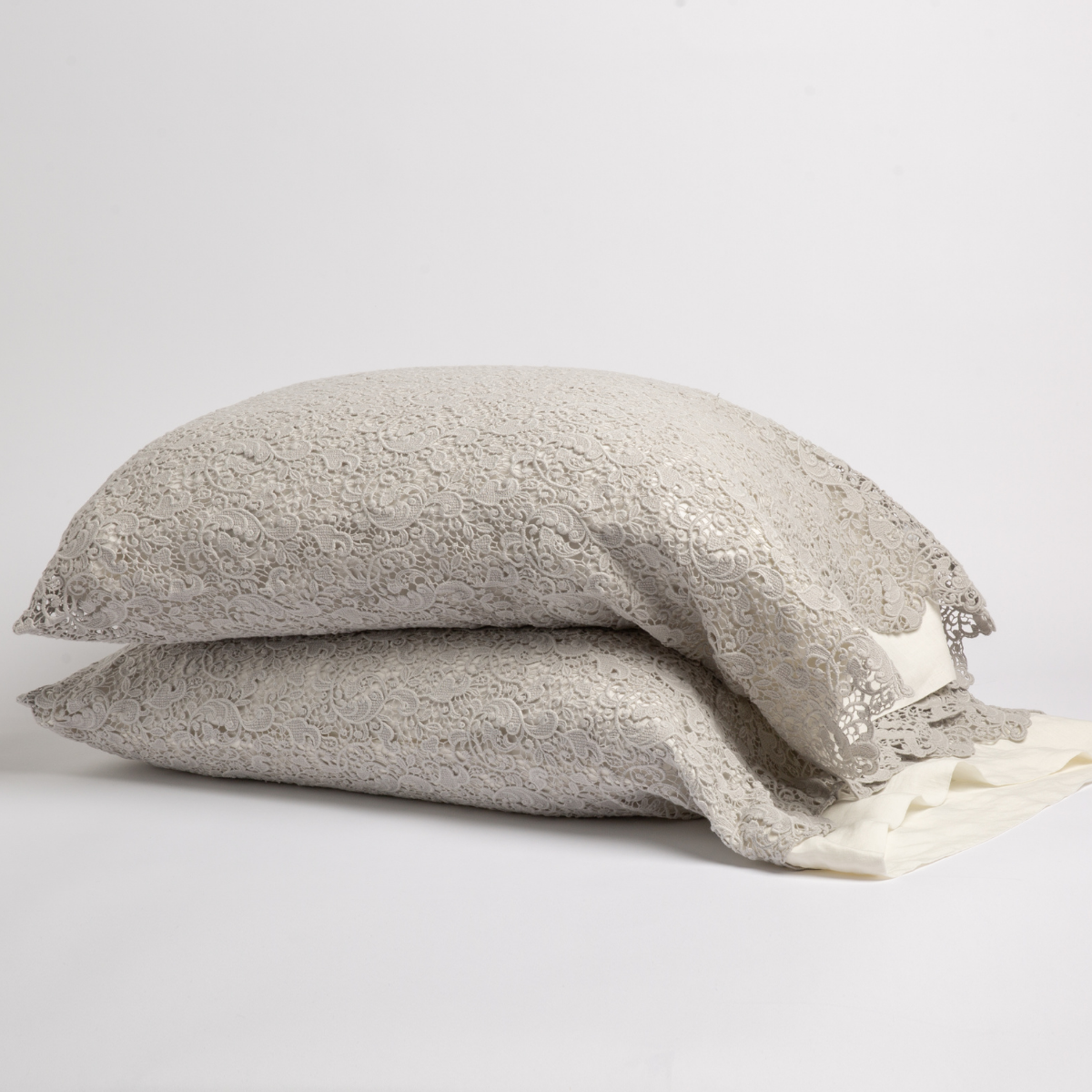 Two stacked Cloud Bella Notte Allora Lace pillowcases with intricate floral lace texture.