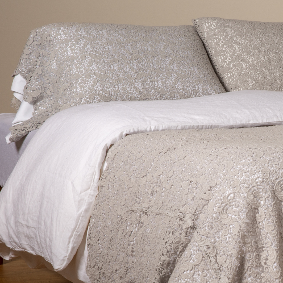 Reverse angle showing Cloud lace pillowcase paired with white bedding on a styled bed.