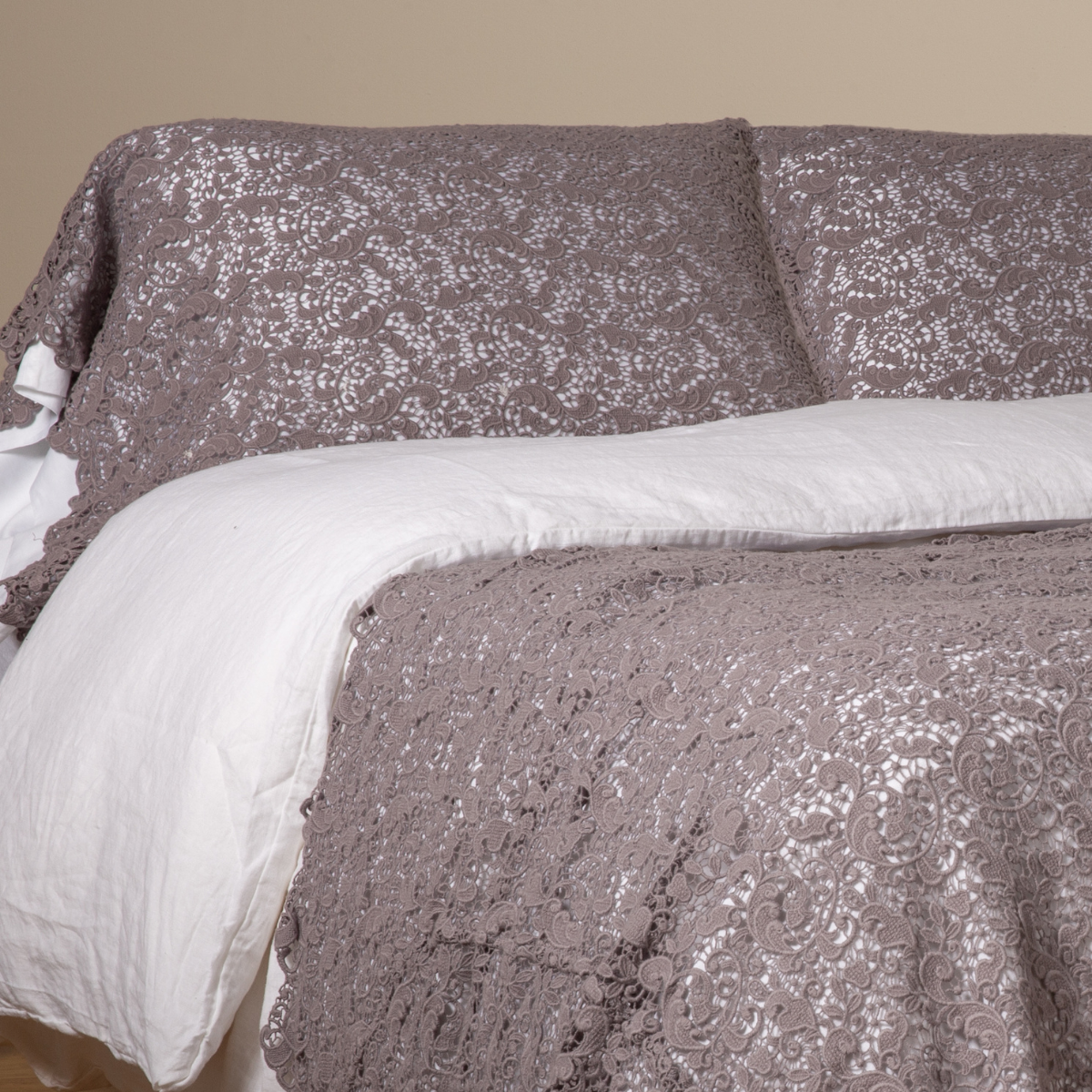 Allora Lace bedding in French Lavender draped over bed, showing duvet and pillowcase together.