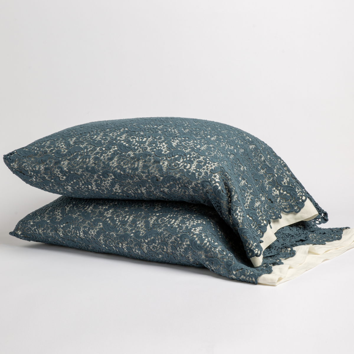 Midnight Allora Lace pillowcases stacked, showing scalloped lace hem detail against white background.
