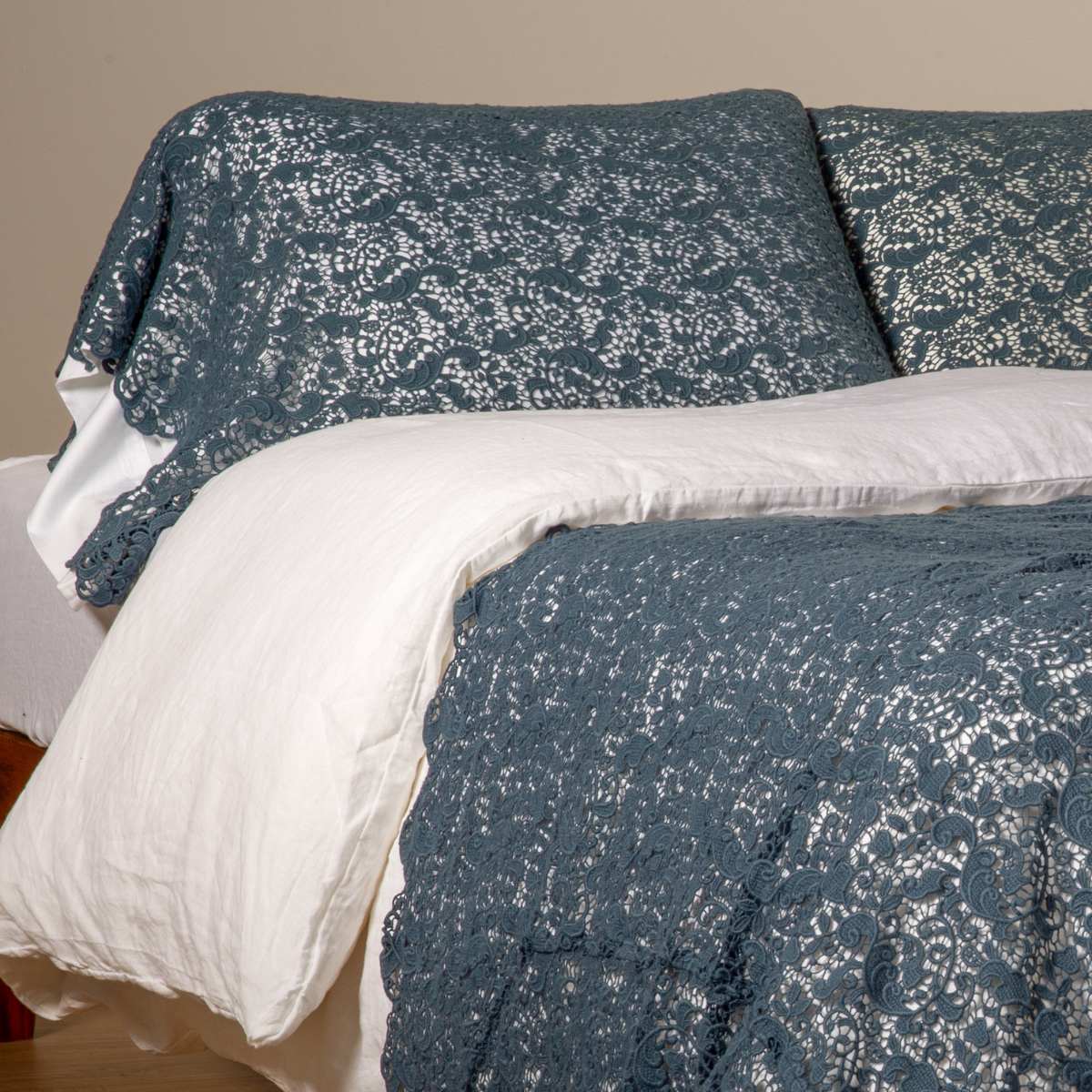 Midnight Allora Lace pillowcases styled on bed with white linen, floral lace texture detail.