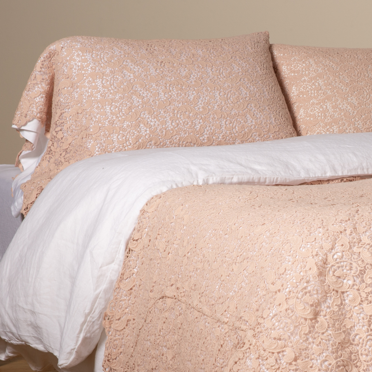 Bella Notte Allora Lace Pearl pillowcase styled on bed with matching lace duvet, soft floral lace detail.