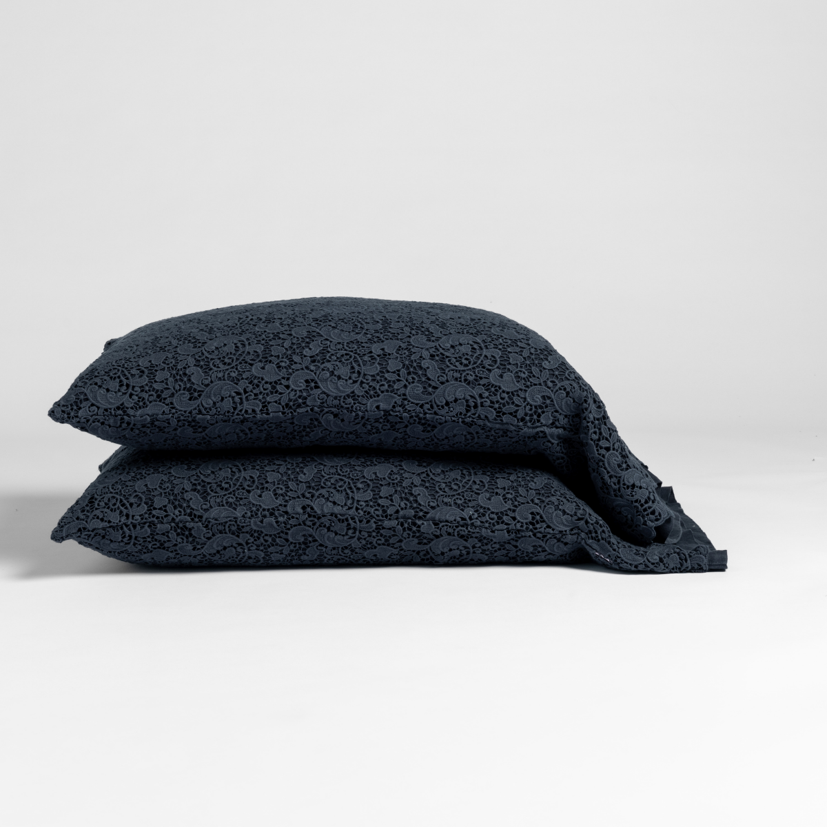 Two stacked Bella Notte Allora Lace pillowcases in Slate with tonal floral lace pattern.