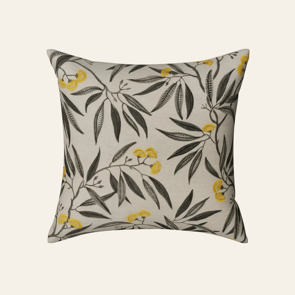 Ann Gish Alyssum pillow in ivory linen with charcoal botanical leaves and golden yellow blooms.